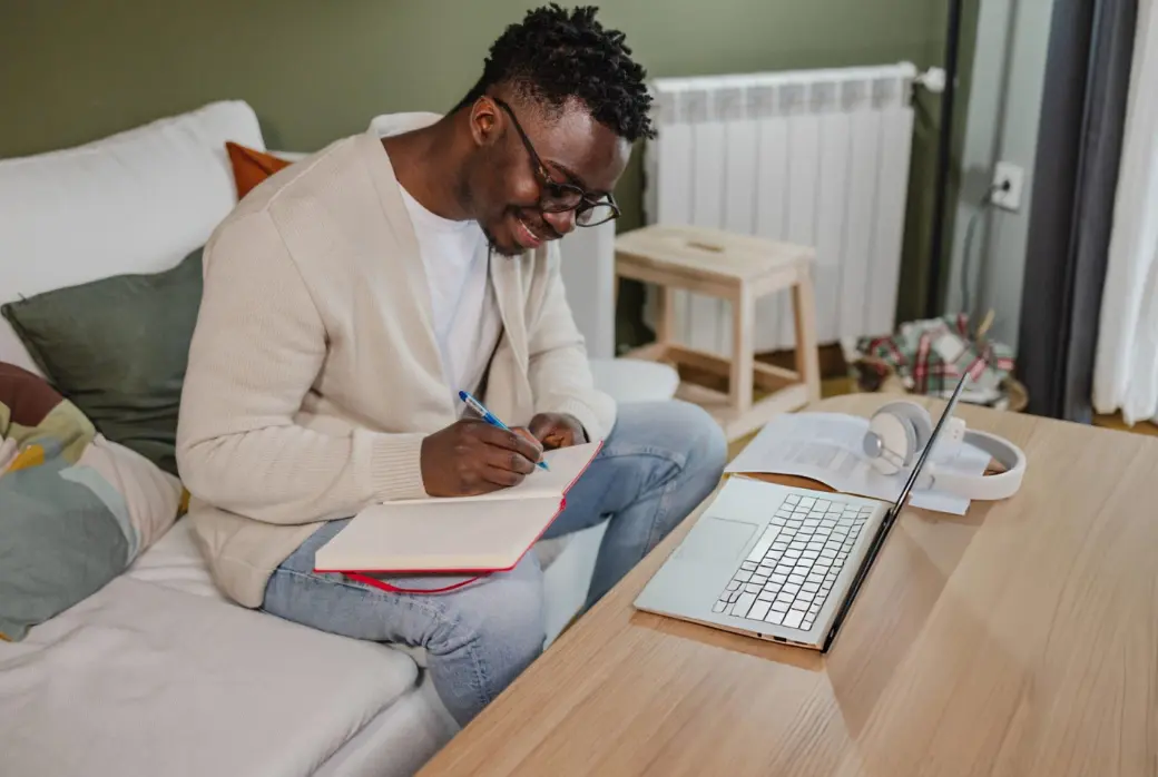 A social work professional studying on a laptop at home
